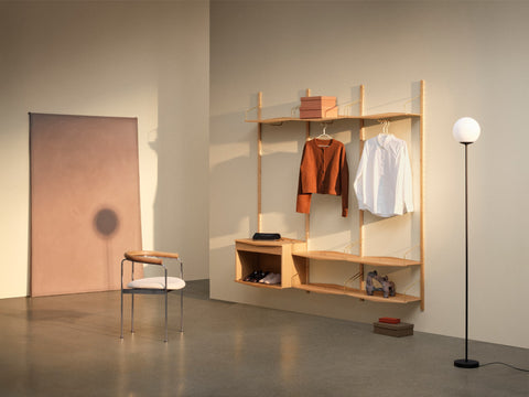 DK3 System Ultra oiled oak wall system with a clothes rail, shelves and a floor lamp