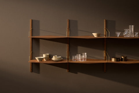 DK3 System Ultra walnut shelves on wall rails with glassware and ceramics