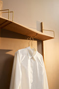 DK3 System Ultra shelf with a clothes rail in oiled oak, a white shirt on a hanger