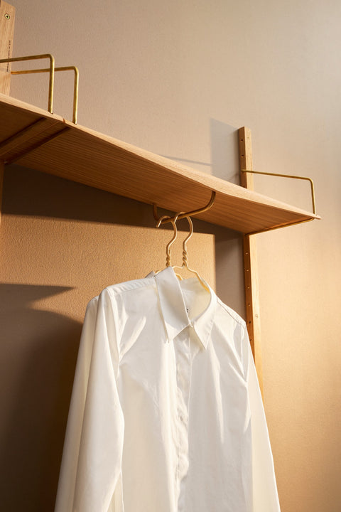 DK3 System Ultra shelf with a clothes rail in oiled oak, a white shirt on a hanger