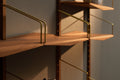 DK3 System Ultra walnut shelves on brass hangers, close view