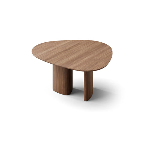 DK3 Tangent Table Round in Walnut, extendable solid wood dining table with an asymmetrical top, angled view on white