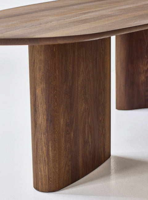 DK3 Tangent Table Rectangular in smoked oak, close view of the curved solid wood base