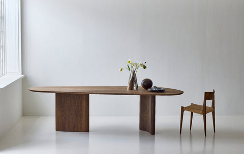DK3 Tangent Table Rectangular in smoked oak beside a window with a wooden chair