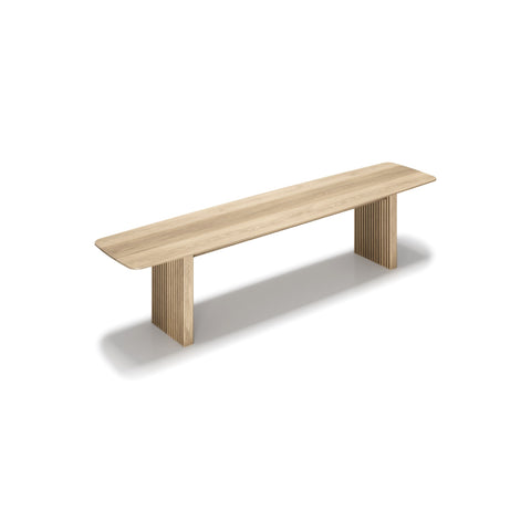 DK3 Ten Bench in White Oiled Oak, solid wood dining bench with grooved legs and a curved top, angled view on white