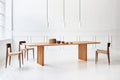 DK3 Ten Table Rectangular in oiled wild oak with paper cord chairs in a white room