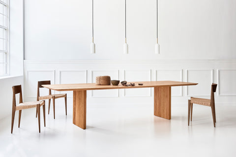 DK3 Ten Table Rectangular in oiled wild oak with paper cord chairs in a white room