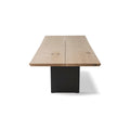 DK3 Tree Table in Soaped Oak, plank dining table with natural edges on black steel legs, view from the end on white
