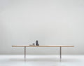 DK3 Tree Table in oak, long solid wood dining table on black powder coated steel legs in a white room