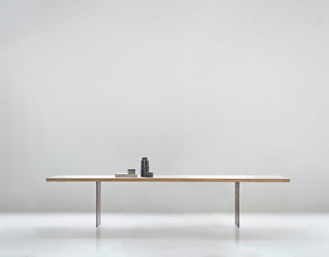DK3 Tree Table in oak, long solid wood dining table on black powder coated steel legs in a white room