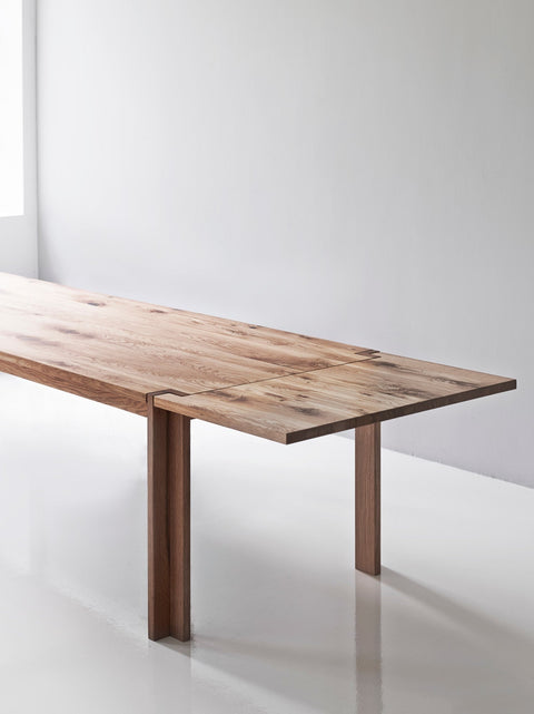 DK3 Jeppe Utzon Table #1 in oiled wild oak, long solid wood dining table in a bright white room