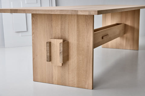 DK3 Jeppe Utzon Table #2 in soaped oak, angled view of the sculpted plank base