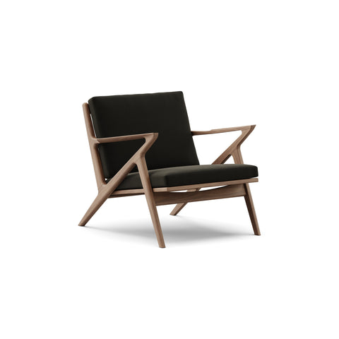DK3 Z Chair in Balmoral Black 99 and Walnut, fabric lounge chair with a Z-shaped solid wood frame, angled view on white