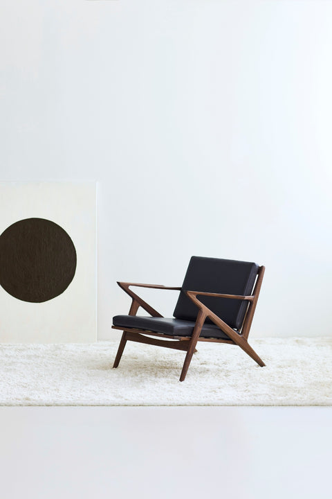 DK3 Z Chair in walnut with dark brown leather on a white rug