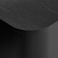 Blu Dot Dally Nightstand in black, close-up detail showing the curved transition between the painted ash veneer top and the powder-coated steel base