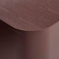 Blu Dot Dally Nightstand in oxblood, close-up detail showing the curved transition between the painted ash veneer top and the powder-coated steel base