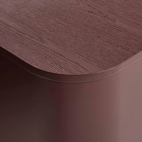 Blu Dot Dally Nightstand in oxblood, close-up detail showing the curved transition between the painted ash veneer top and the powder-coated steel base
