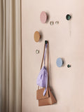 Muuto Dots in ceramic finish displayed on a minimalist wall, showcasing modern, stylish wall hooks in a variety of soft neutral tones.