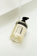 Humdakin 01 Hand Soap, Chamomile & Sea Buckthorn, liquid hand soap, bottle lying in a white basin under running water
