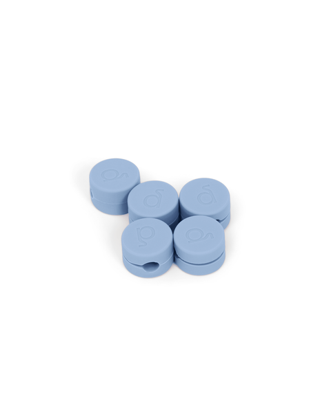 Pedestal Cable Clips in Powder Blue, five magnetic silicone cable clips grouped together, on a plain white background