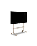 Pedestal Rover TV Stand in Oat, TV stand on wheels with a structural shelf holding a flat screen TV, on a plain white background