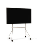 Pedestal Moon PRO TV Stand in Oat, mobile rolling TV stand with shelf holding a flat screen TV, on a plain white background