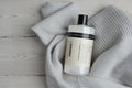Humdakin 01 Wool & Cashmere Detergent, wool wash detergent, bottle lying on a grey knit sweater on a pale wood floor