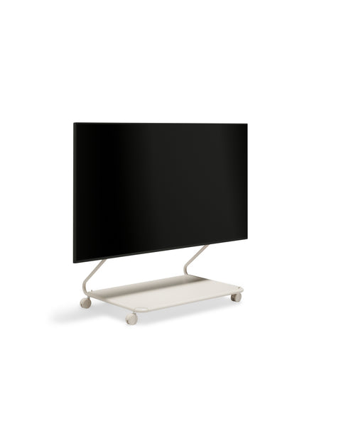 Pedestal Disco TV Stand in Oat, minimalist low TV stand with an integrated shelf holding a flat screen TV, on a plain white background