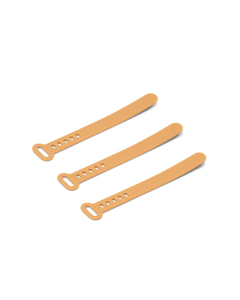 Pedestal Cable Tie in Apricot, three silicone cable ties laid side by side, on a plain white background