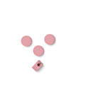 Pedestal Cable Dots in Bubble Gum, silicone cable dots with a mounting clip, on a plain white background