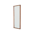 Frama Symmetry Mirror, tall rectangular mirror in a brown wood frame photographed at an angle so the depth of the frame shows