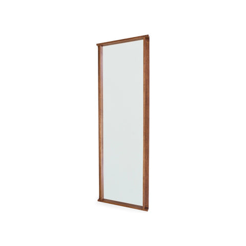 Frama Symmetry Mirror, tall rectangular mirror in a brown wood frame photographed at an angle so the depth of the frame shows