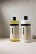 Humdakin 01 Laundry Soap, Chamomile & Sea Buckthorn, liquid laundry detergent, laundry soap and fabric softener bottles side by side against a grey wall
