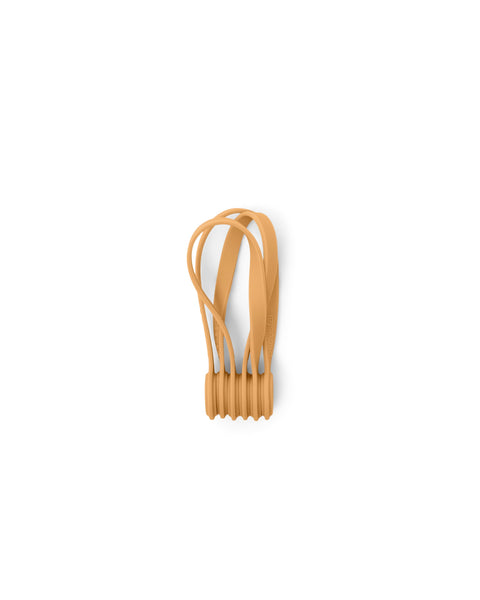 Pedestal Magnetic Cable Ties in Apricot, three magnetic silicone cable ties, on a plain white background