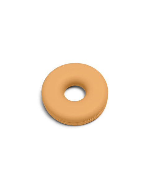 Pedestal Cable Bagel in Apricot, silicone cable organizer ring, on a plain white background