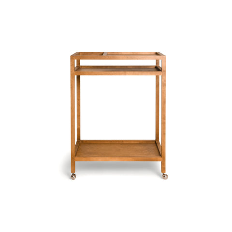 Frama Ratio Trolley in Warm Brown Birch, two tier birch trolley on small castors with a slim square frame, angled view on white