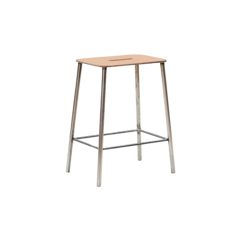 Frama Adam Stool, low stool seen from a slight angle, leather seat over four tapered raw steel legs and a wire brace