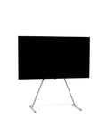 Pedestal Viva TV Stand in Oat, TV floor stand holding a flat screen TV, on a plain white background