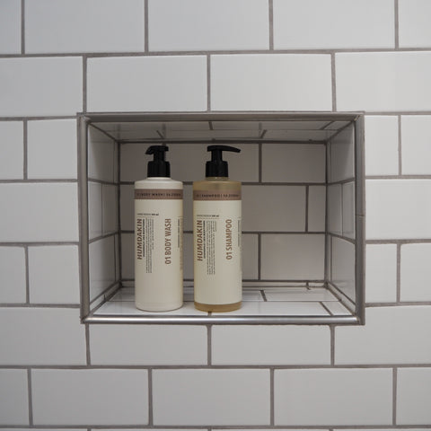 Humdakin 01 Shampoo, Chamomile & Sea Buckthorn, hair shampoo, shampoo and conditioner in a white subway-tiled shower niche