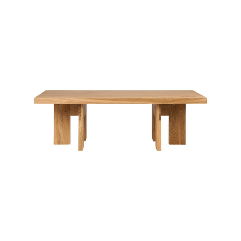Frama Farmhouse Coffee Table in Natural Oak, long rectangular oak top on paired plank legs, seen from the side on white