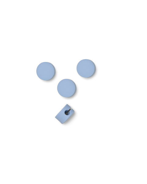 Pedestal Cable Dots in Powder Blue, silicone cable dots with a mounting clip, on a plain white background