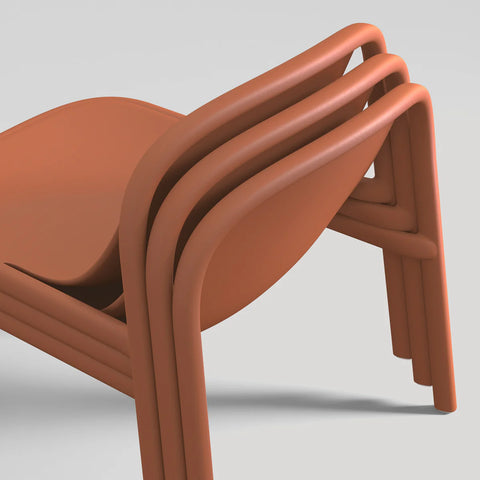 Blu Dot Decade Lounge Chair in terracotta recycled plastic, close-up showing three chairs stacked together demonstrating the stackable design