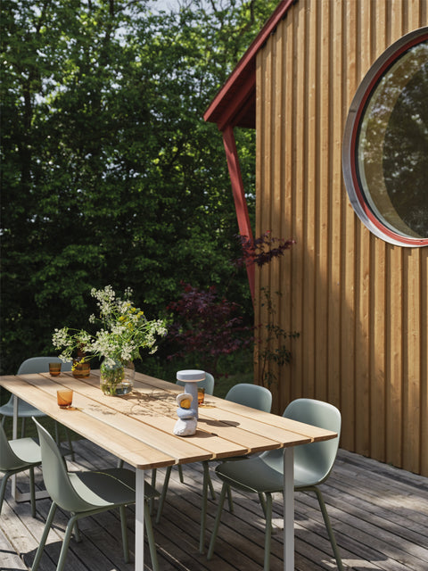 fiber outdoor side chairs in dusty green and wood slat 70 70 table by muuto 