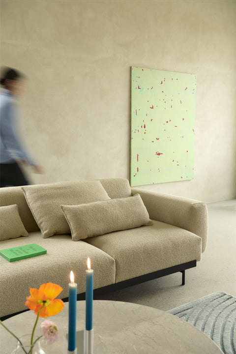 Detail of Midst Coffee Table marble top with flowers and candles, paired with In Situ sofa in contemporary interior
