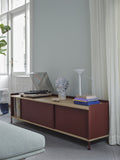 muuto enfold sideboard with a record player used as a media stand in a living room