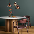 Blu Dot 4/4 Round Dining Table with marble top and walnut base in a moody teal dining room