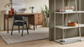 Blu Dot Cursive Desk in walnut styled in a modern home office with shelving unit and side chair