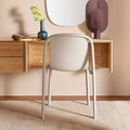 Blu Dot Decade Chair in putty recycled plastic, styled in a modern entryway beside a floating oak console with a rounded mirror and decorative accessories