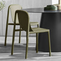 Blu Dot Decade Chairs in olive recycled plastic, styled around a black round dining table on a weathered wood patio