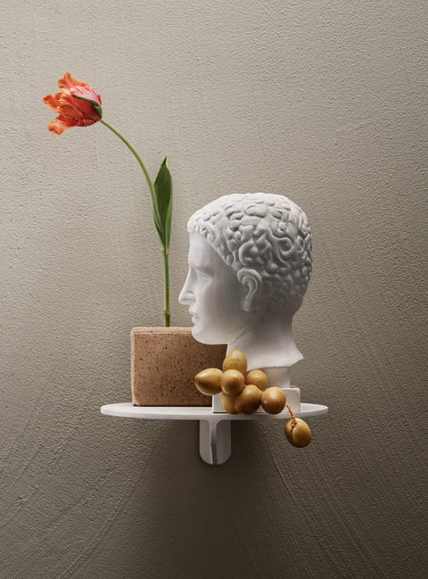 Museum NM&.045 shelf by String™ in white styled with a classical bust, terracotta pot with tulip, and golden grapes